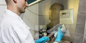 Researcher using a pipette in a fume hood